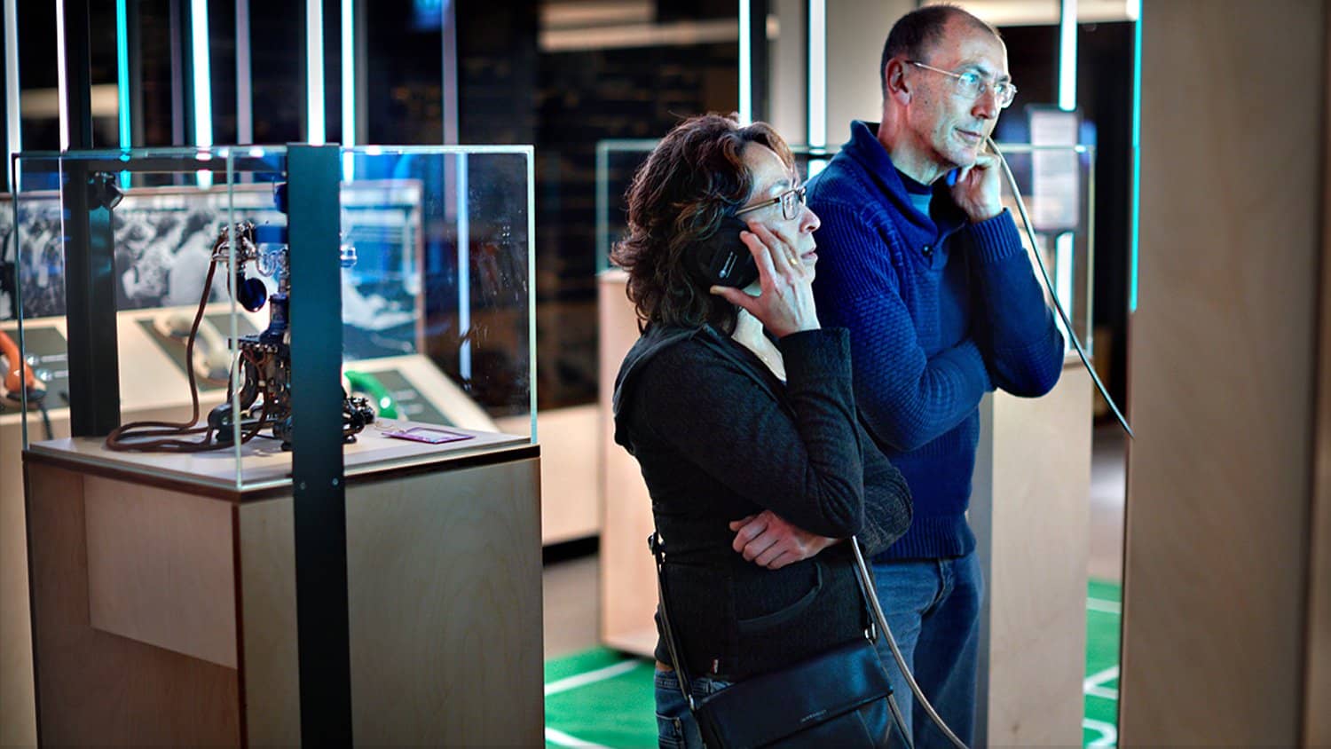 Visitors using AutoPlay Single Cup Headphones at the COMM Museum