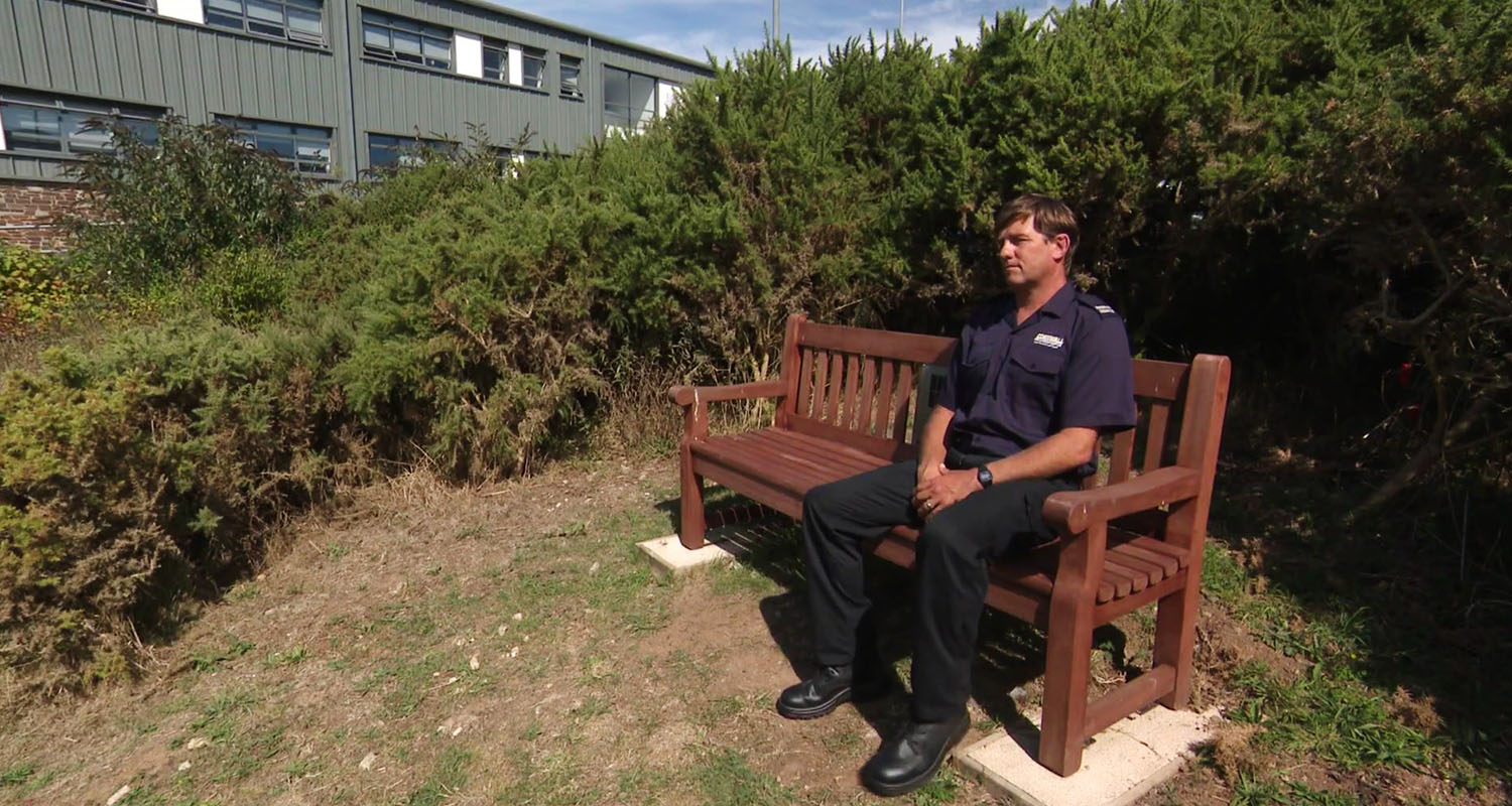 Man sitting on Echo Point Audio Bench