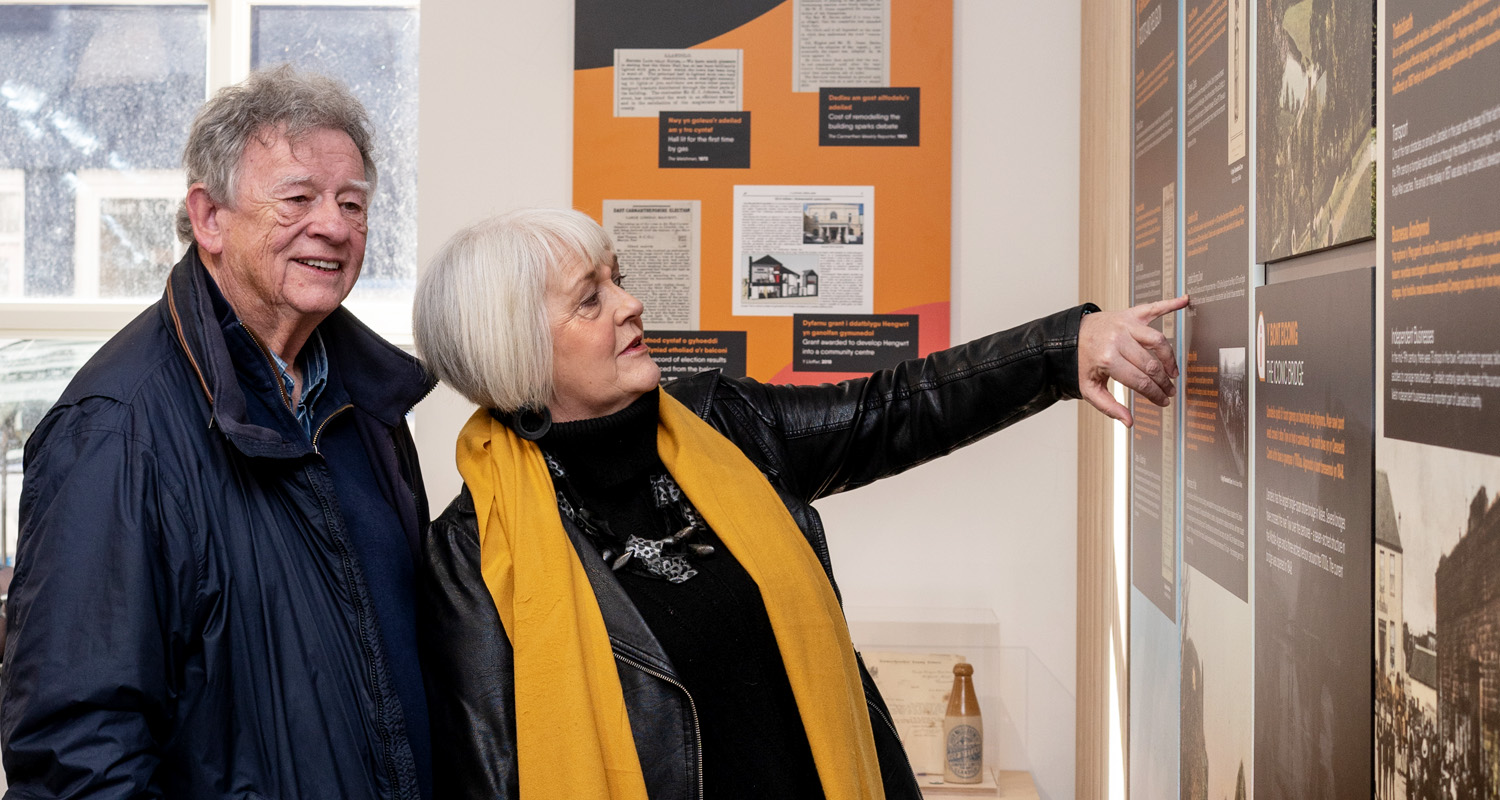 Couple pointing at signage at Llandeilo Heritage Centre landscape