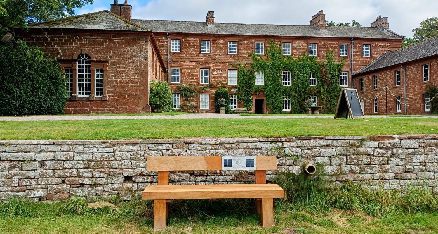 Heavy Duty Solar Audio Bench outside house at Acorn Bank